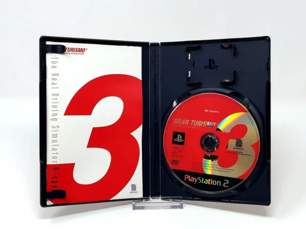 Interior del juego Gran Turismo 3: A-Spec (JAP) para PlayStation 2 con disco y manual