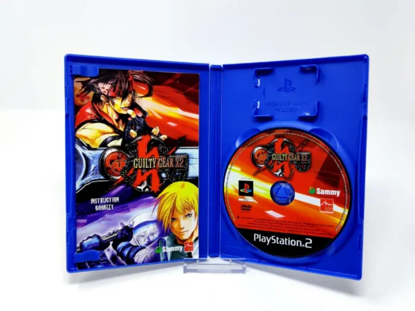 Interior del juego Guilty Gear X2 (UK) para PlayStation 2 con disco y manual