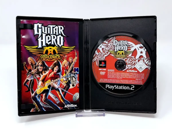 Interior del juego Guitar Hero: Aerosmith (ESP) para PlayStation 2 con disco y manual
