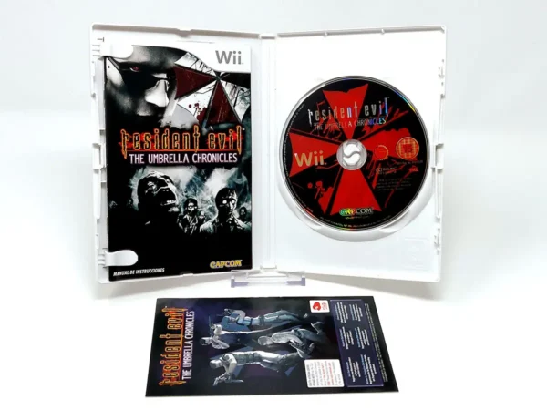 Interior del juego Resident Evil: The Umbrella Chronicles (ESP) para Nintendo Wii con disco y manual