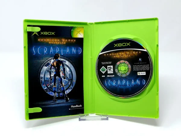 Interior del juego American McGee Presents Scrapland (ALE) para XBOX con disco y manual