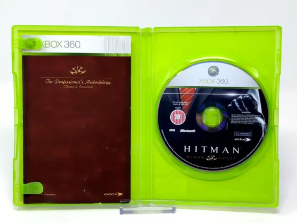 Interior del juego Hitman: Blood Money (UK) para XBOX 360 con disco y manual