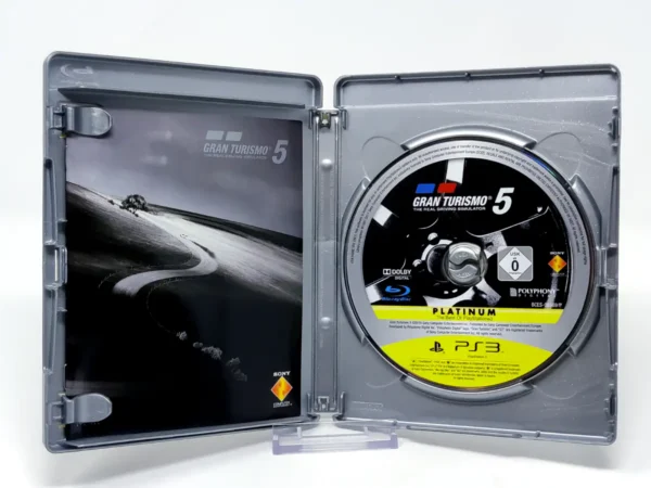 Interior del juego Gran Turismo 5 (ESP) (Platinum) para PlayStation 3 con disco y manual
