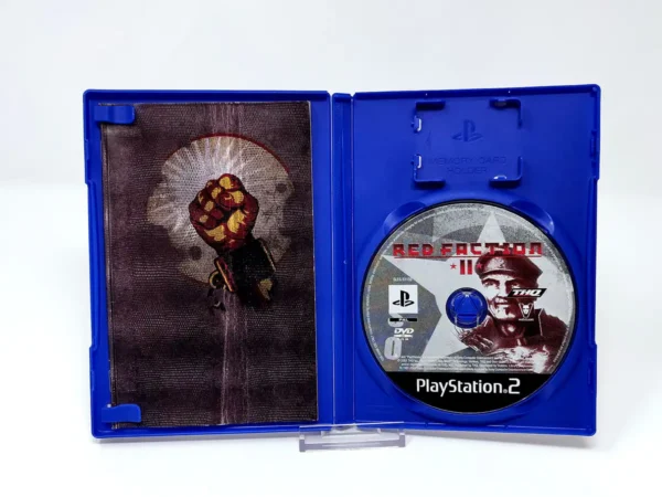 Interior del juego Red Faction II (FRA) para PlayStation 2 con disco y manual