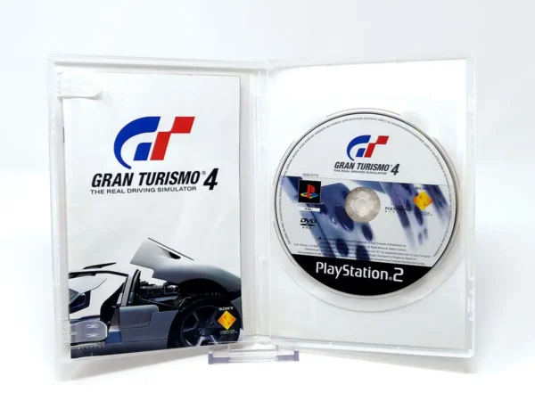 Interior del juego Gran Turismo 4 (ITA) (Platinum) para PlayStation 2 con disco y manual