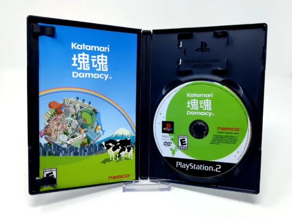 Interior del juego Katamari Damacy (USA) para PlayStation 2 con disco y manual