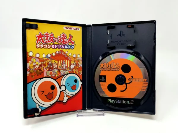 Interior del juego Taiko no Tatsujin: Tatacon de Dodon ga Don (JAP) para PlayStation 2 con disco y manual