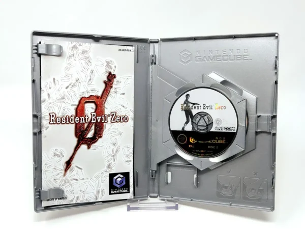Interior del juego Resident Evil: Zero (FRA) para Nintendo GameCube con disco y manual