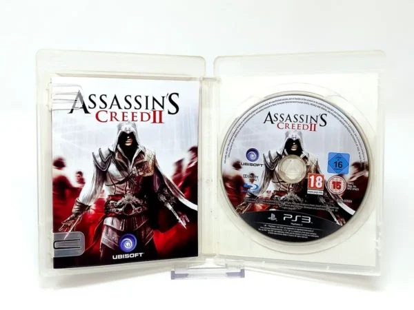 Interior del juego Assassin's Creed II (ESP) (v1) para PlayStation 3 con disco y manual