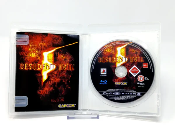 Interior del juego Resident Evil 5 (ESP) para PlayStation 3 con disco y manual