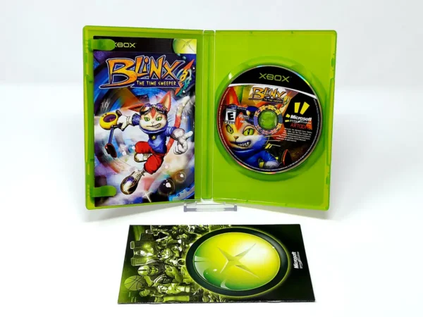 Interior del juego Blinx: The Time Sweeper (USA) para XBOX con disco y manual