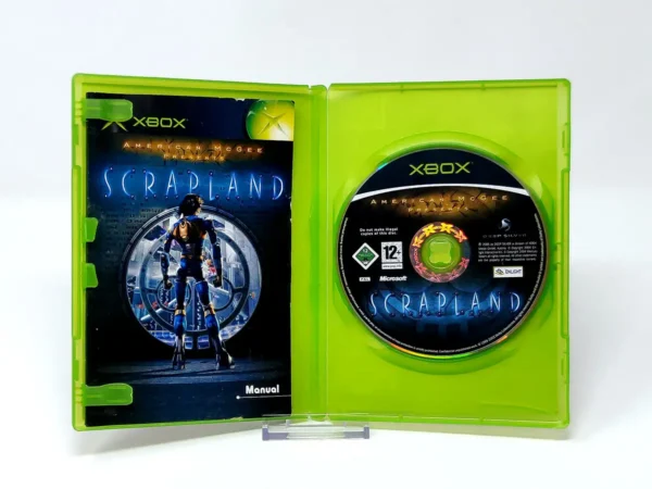 Interior del juego American McGee Presents Scrapland (ESP) para XBOX con disco y manual