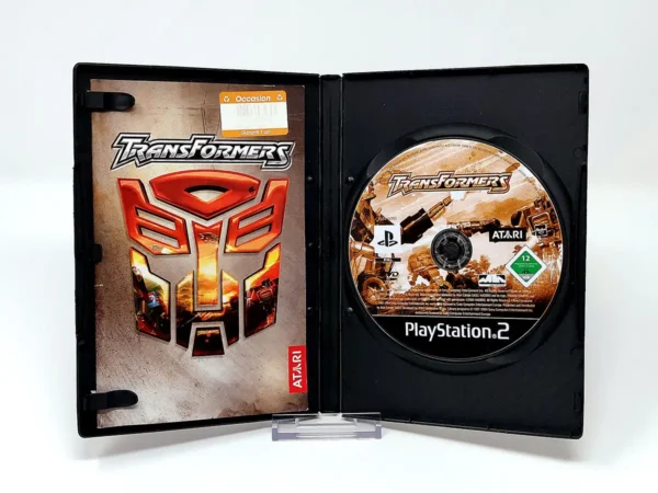 Interior del juego Transformers (FRA) para PlayStation 2 con disco y manual