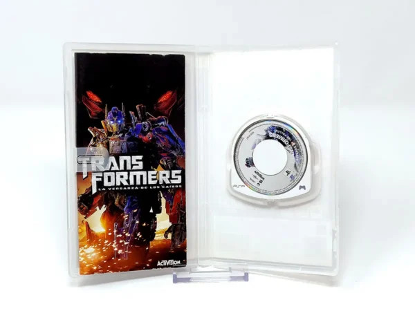 Interior del juego Transformers: La Venganza de los Caídos (ESP) para PSP con disco y manual