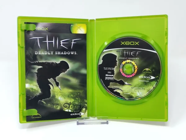 Interior del juego Thief: Deadly Shadows (ESP) para XBOX con disco y manual