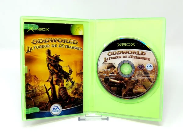 Interior del juego Oddworld: La Fureur de l'Etranger (FRA) para XBOX con disco y manual