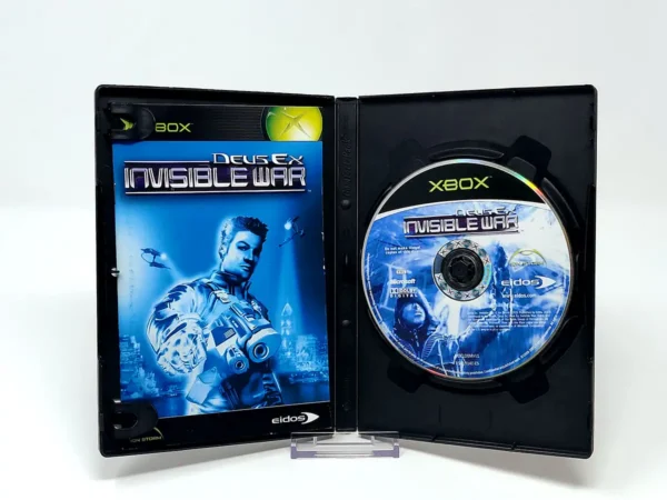 Interior del juego Deus Ex: Invisible War (FRA) para XBOX con disco y manual