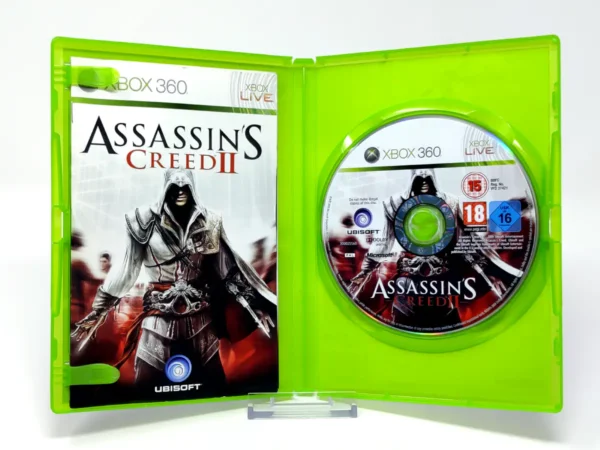 Interior del juego Assassin's Creed II (ITA) para XBOX 360 con disco y manual