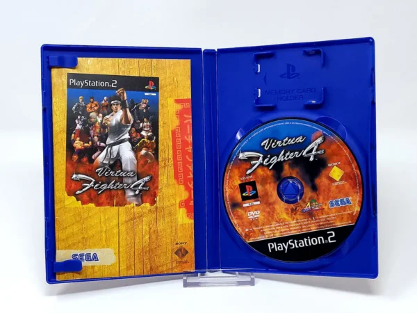 Interior del juego Virtua Fighter 4 (FRA) para PlayStation 2 con disco y manual