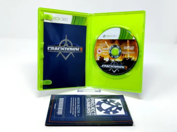 Interior del juego Crackdown 2 (UK) para XBOX 360 con disco y manual