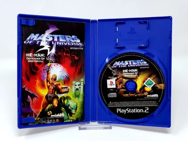 Interior del juego Masters of the Universe: He-Man - Defender of Grayskull (FRA) para PlayStation 2 con disco y manual