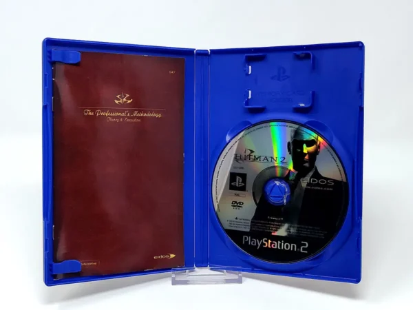 Interior del juego Hitman 2: Silent Assassin (POR) para PlayStation 2 con disco y manual