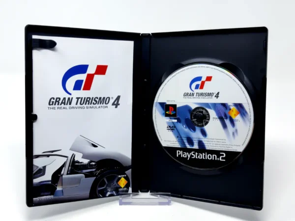 Interior del juego Gran Turismo 4 (ESP) (v2) para PlayStation 2 con disco y manual