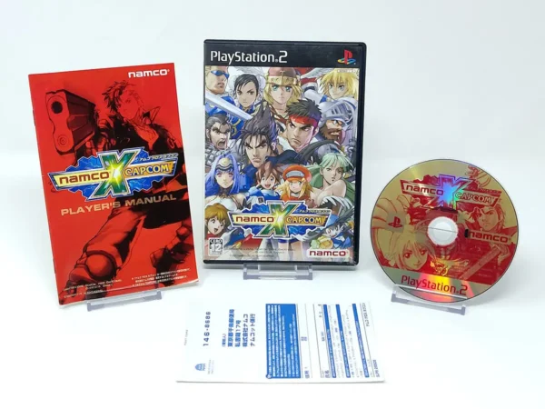 Interior del juego Namco x Capcom (JAP) para PlayStation 2 con disco y manual