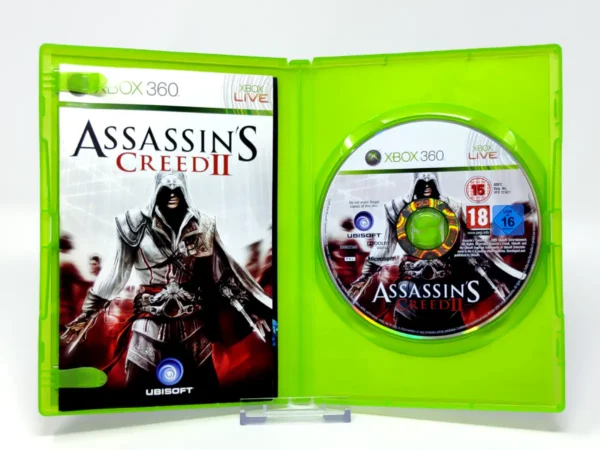 Interior del juego Assassin's Creed II (ESP) para XBOX 360 con disco y manual