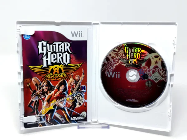 Interior del juego Guitar Hero: Aerosmith (ESP) para Nintendo Wii con disco y manual