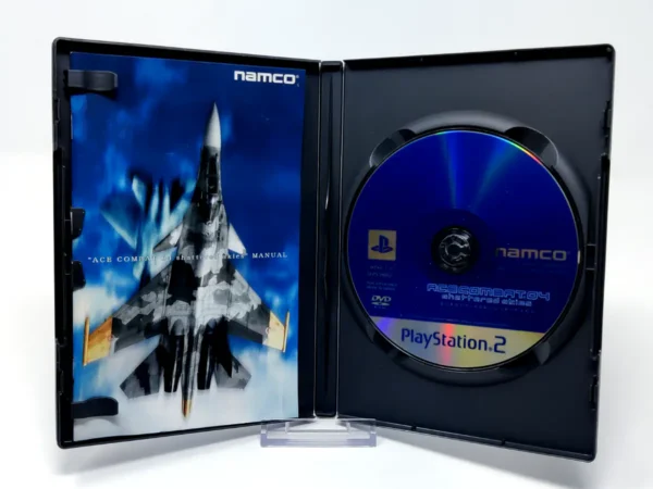 Interior del juego Ace Combat 04: Shattered Skies (JAP) para PlayStation 2 con disco y manual