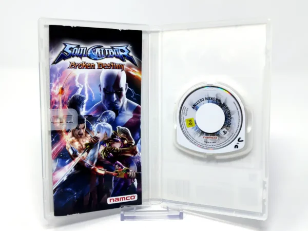 Interior del juego Soulcalibur: Broken Destiny (ESP) (Essentials) para PSP con disco y manual