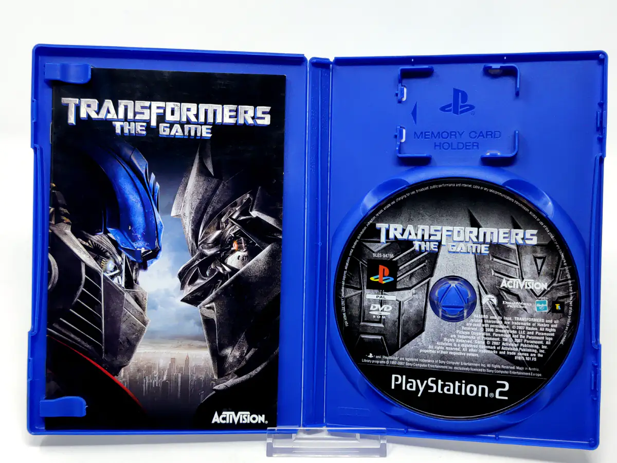 Interior del juego Transformers: The Game (ESP) para PlayStation 2 con disco y manual