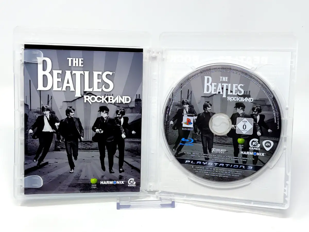 Interior del juego The Beatles: Rock Band (ESP) para PlayStation 3 con disco y manual