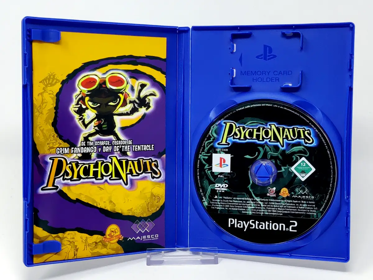 Interior del juego Psychonauts (ESP) para PlayStation 2 con disco y manual